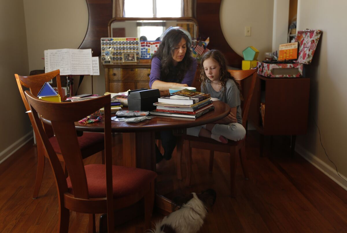 Kimberly Rotter worked on school work with her daughter Moxie at their home in October.