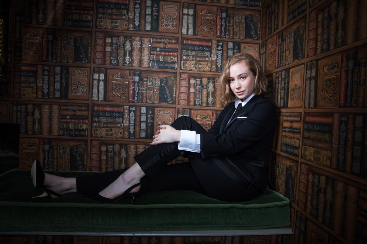Hannah Einbinder, comedian and actress starring in HBO's "Hacks," poses for a portrait in front of a faux bookcase