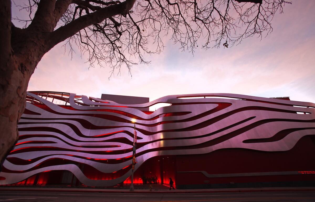 The Petersen Automotive Museum and its controversial facade glows at dawn in Los Angeles.