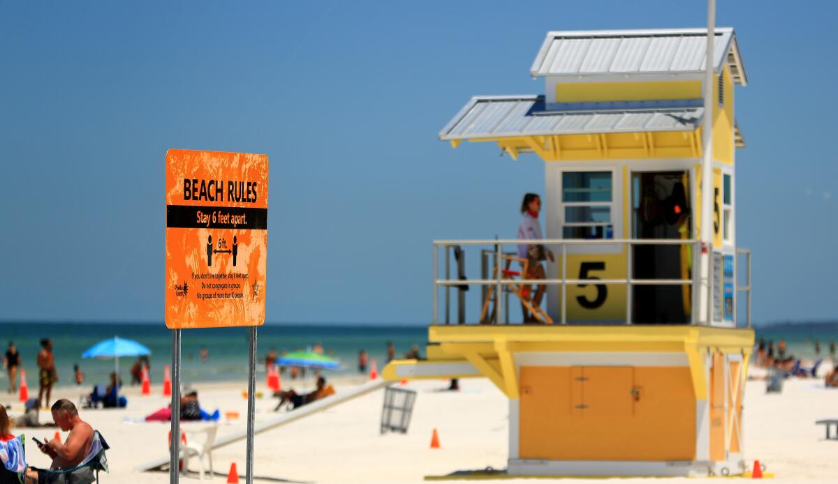 Beaches opened with new rules Monday in Clearwater Beach, Fla. Dozens of states have begun easing restrictions amid the COVID-19 pandemic.