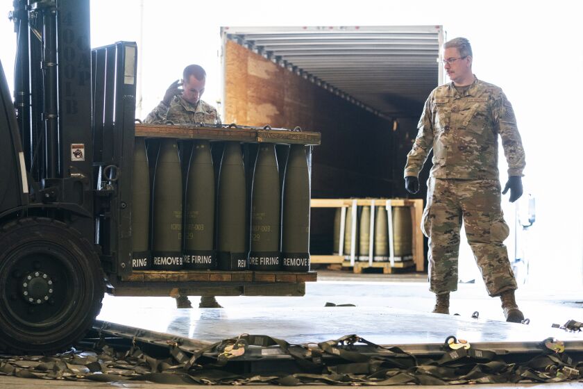 FILE - Airmen with the 436th Aerial Port Squadron place 155 mm shells on aircraft pallets ultimately bound for Ukraine, April 29, 2022, at Dover Air Force Base, Del. Half of the people in the U.S. support the Pentagon's ongoing supply of weapons to Ukraine for its defense against Russian forces. That's according to a new survey by the University of Chicago's Harris School of Public Policy and NORC. (AP Photo/Alex Brandon, File)