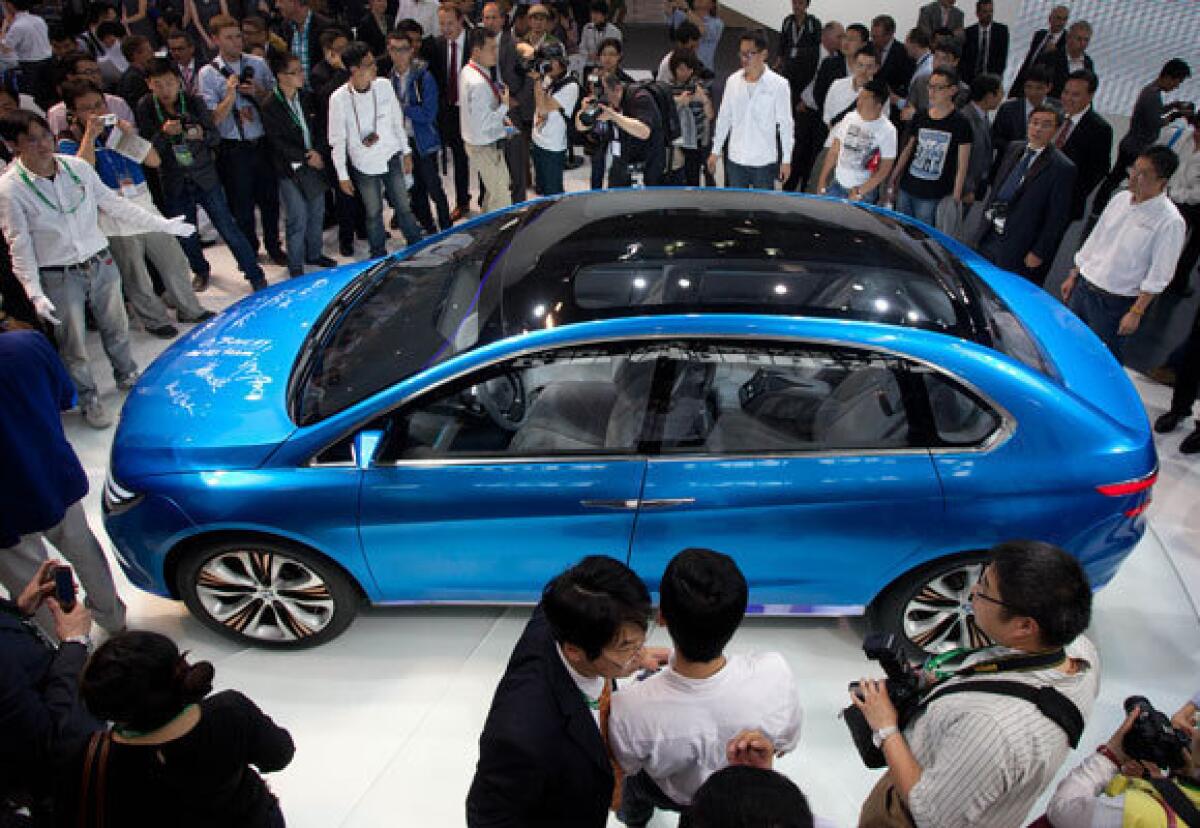 The Denza electric car, created jointly by Daimler and Chinese manufacturer BYD, is unveiled April 23 at the Auto China 2012 car show in Beijing. The EVS26 symposium opening Sunday in L.A. will see a few new electric cars but is about the entire electric vehicle infrastructure.