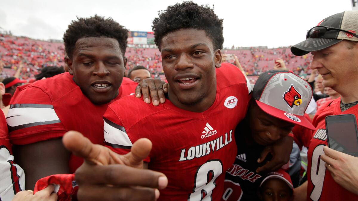 Quarterback Lamar Jackson (8) celebrates after Louisville's dismantling of Florida State on Saturday.