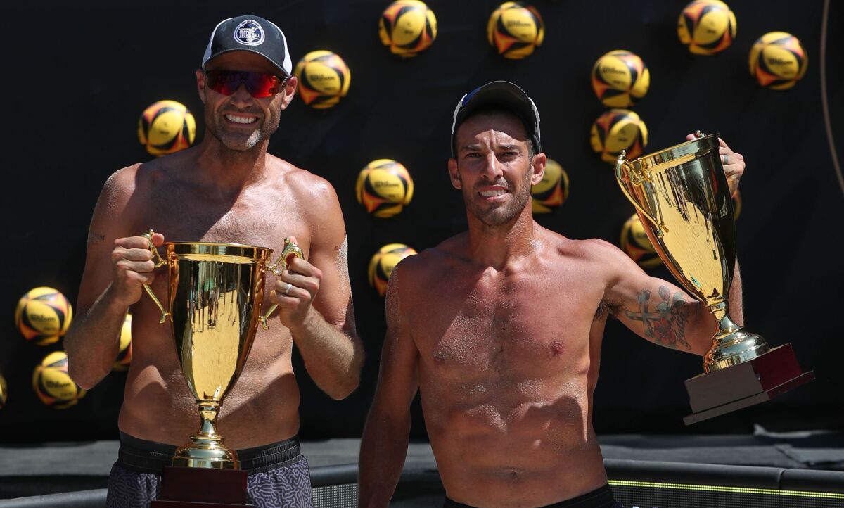 Phil Dalhausser, left, and Nick Lucena celebrate their victory at the AVP tournament in Long Beach on Juky 26, 2020.