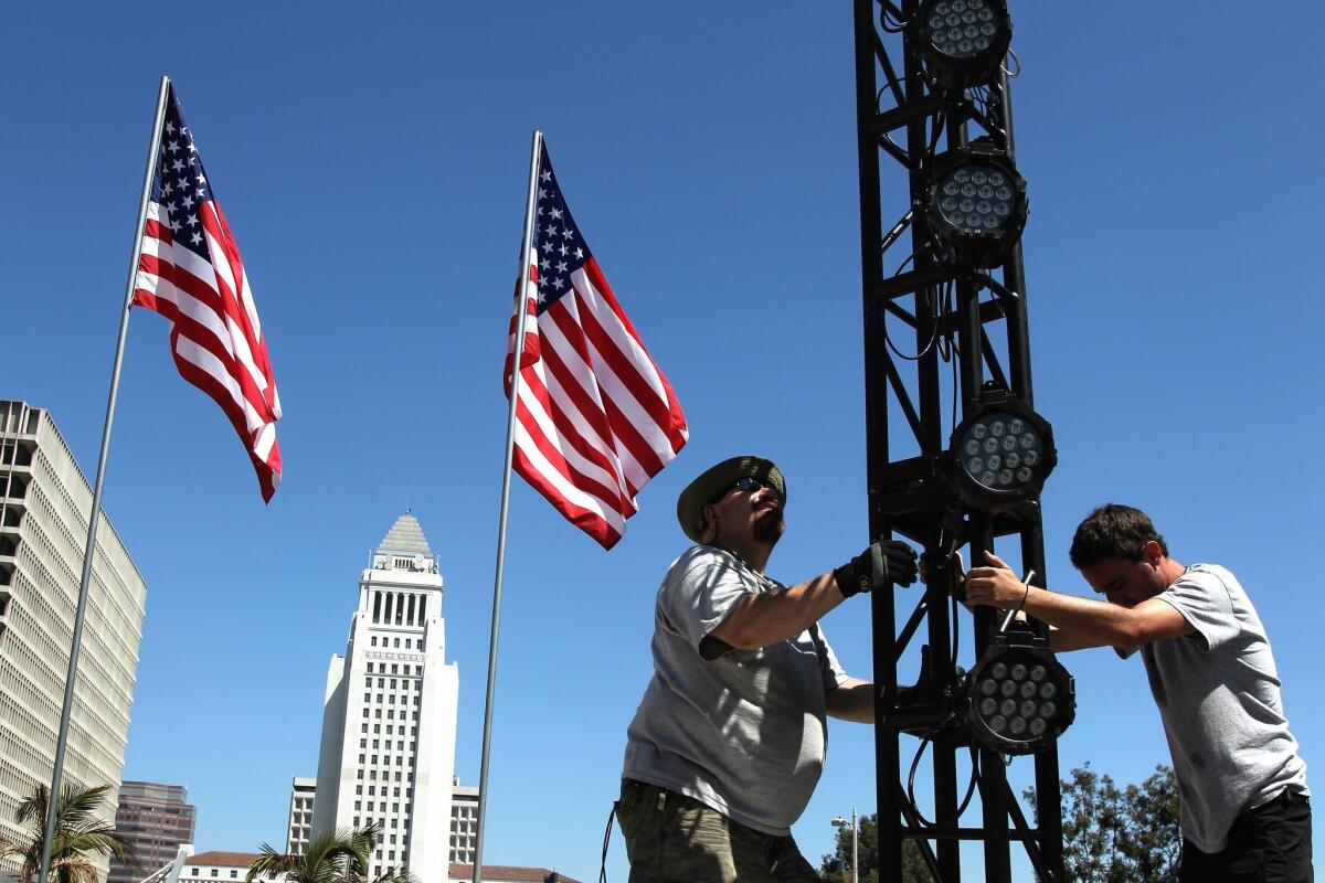 Workers prepare Grand Park for the Fourth of July celebration.