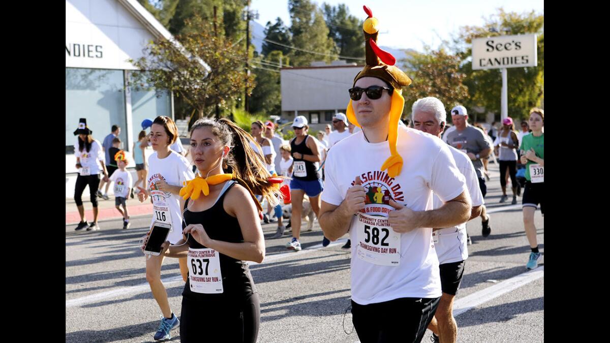 Runner #637 Brittany Johnson, left, and #582 Joel Avery wore festive attire to the 2017 Thanksgiving Day Run & Food Drive, presented by the Community Center of La Cañada Flintridge. Registration is open for this year's event.