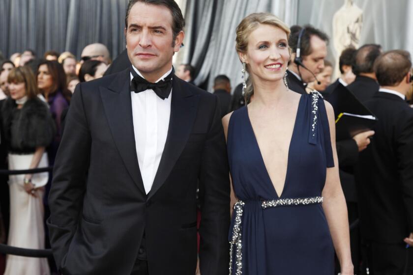 Jean Dujardin of "The Artist" and wife Alexandra Lamy have split. Here the couple appear at the 84th Academy Awards show in Los Angeles in 2012.