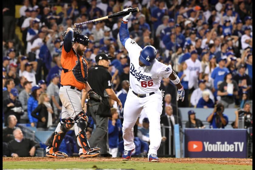 The Dodgers' Yasiel Puig slams his bat into the ground after popping up with two runners on base in the third inning.