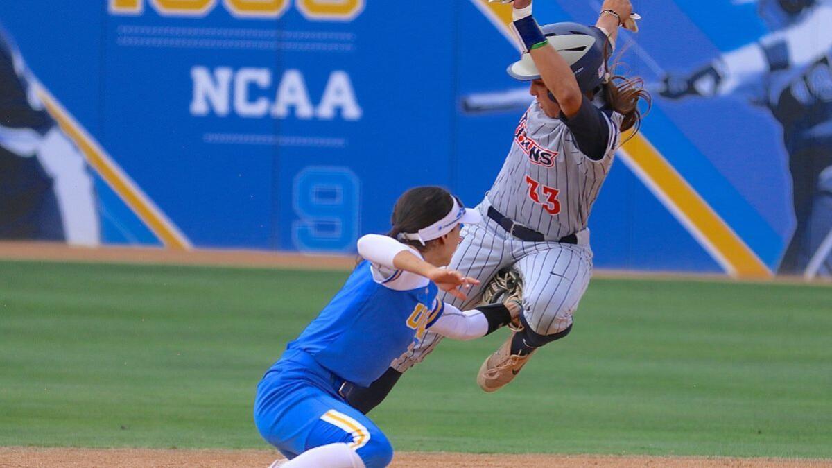 UCLA shortstop Briana Perez tags out Fullerton runner Kelsie Whitmore before she steals second base in the fourth inning of a Los Angeles Regional softball game at Easton Stadium on May 20. UCLA won 3-0.