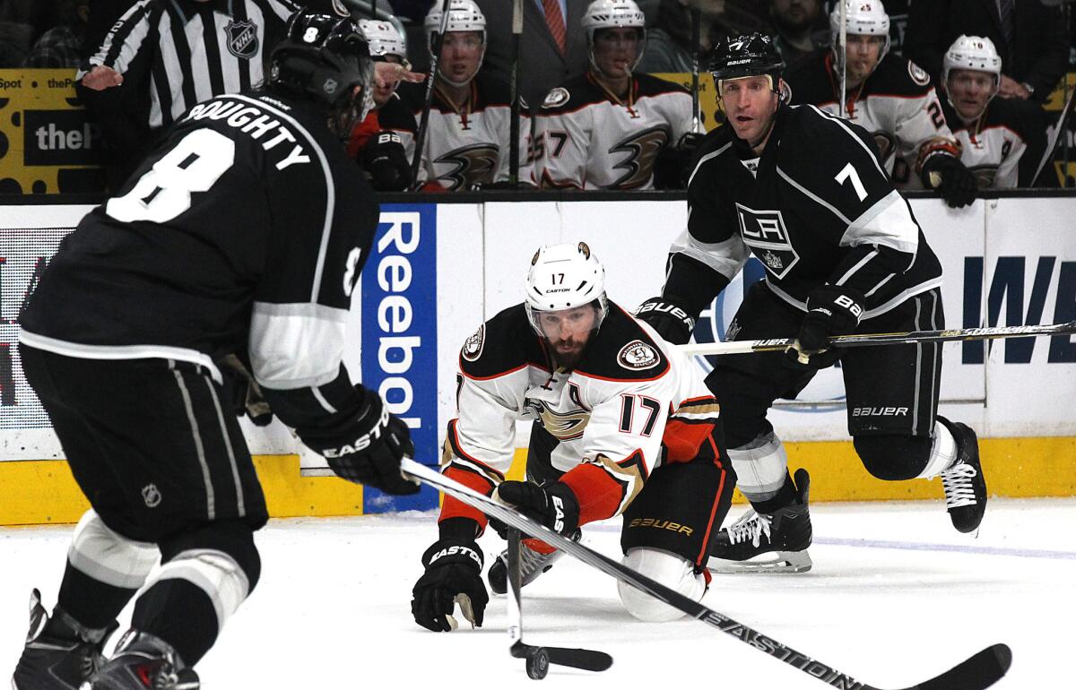 Ducks center Ryan Kessler goes to the ice as he fights for control of the puck against the Kings during the second period of a game on March 5 at Staples Center.