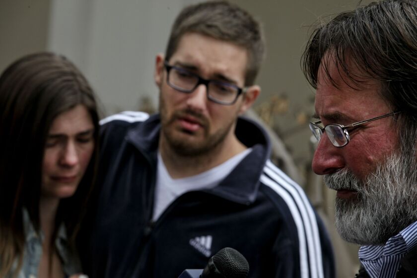 Richard Martinez -- right, the father of UCSB sophomore Christopher Martinez, who was killed in Isla Vista on Friday night -- speaks to reporters Saturday afternoon. Christopher Martinez's cousin, center, and an unidentified family member joined Martinez.