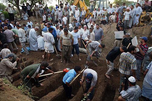 Men dig graves for victims of the massive truck bombing in Taza Khurmatu, a mostly Shiite Turkmen town about 10 miles south of Kirkuk. Islamic tradition calls for swift burial.