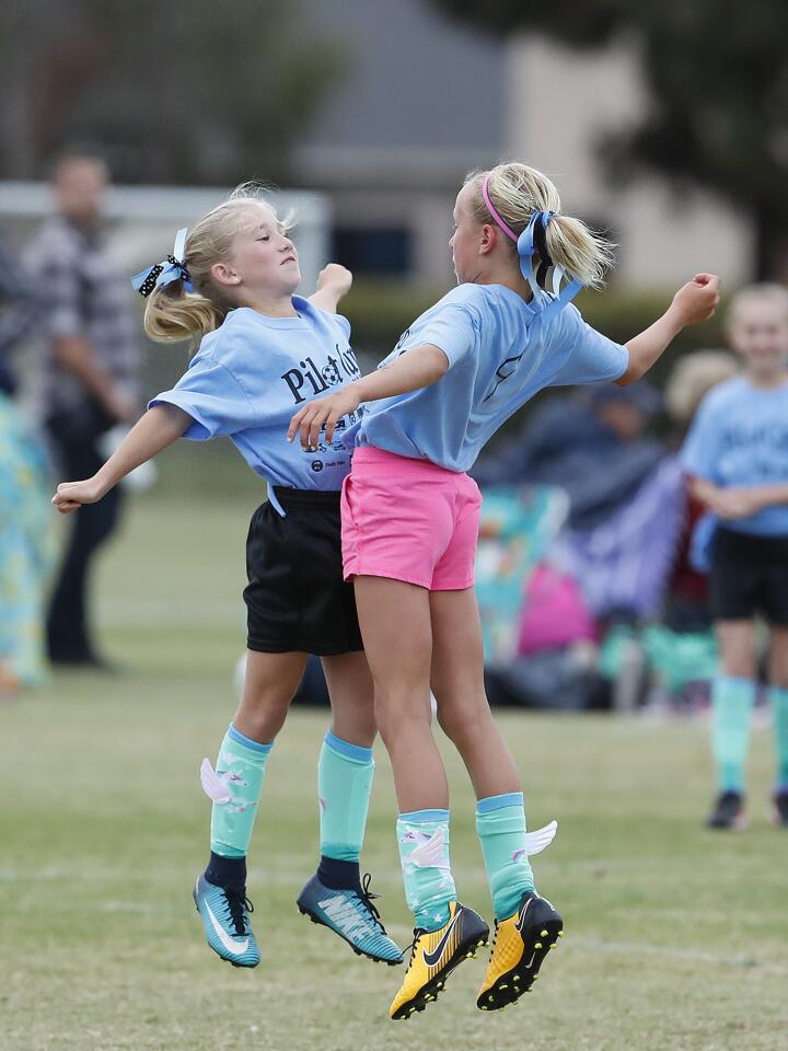Andersen B's Caroline Morehouse, left, chest bumps Ella Olson after Olson scored a goal during a game against Eastbluff B in a girls' third- and fourth-grade Silver Division at the Daily Pilot Cup on Wednesday, May 30.