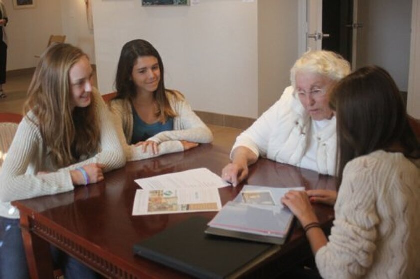 Nora Joyce and Lizzie Craig chat with Mary Jane Fee about her grandchildren and living in La Jolla, while Dara Pite shows an example of a scrapbook they could make if Fee signs up for Silver Stories. Ashley Mackin