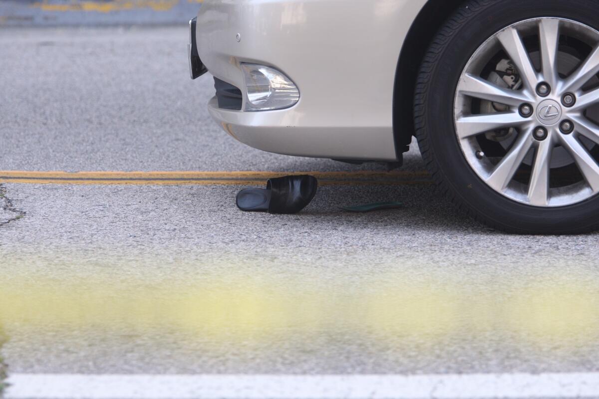 A woman's shoe remains near the front wheel of the car that struck her in Glendale on Friday, May 13, 2016.