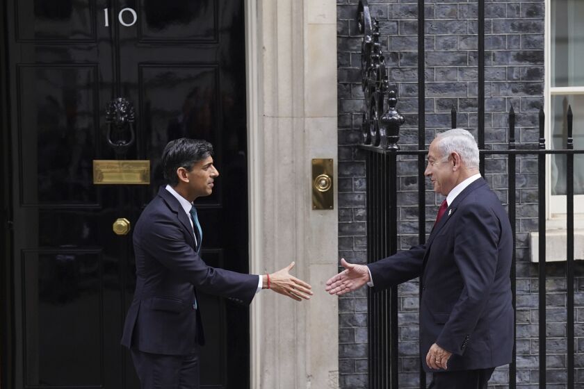 Britain's Prime Minister Rishi Sunak, left, welcomes Israel Prime Minister Benjamin Netanyahu at Downing Street in London, Friday, March 24, 2023. (Stefan Rousseau/PA via AP)