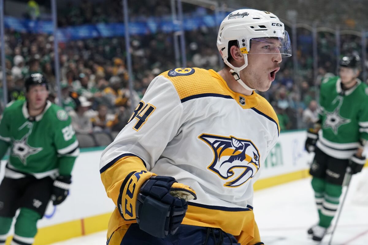 Nashville Predators left wing Tanner Jeannot celebrates scoring in the second period of an NHL hockey game against the Dallas Stars in Dallas, Wednesday, Nov. 10, 2021. (AP Photo/Tony Gutierrez)