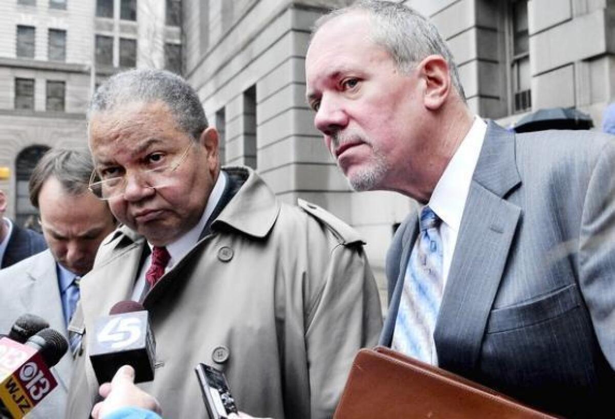 Defense attorney A. Dwight Pettit, left, and his client, Paul Schurick, former campaign manager for Gov. Robert L. Ehrlich Jr., take questions from reporters after Schurick was found guilty of election fraud for his role in an election day 2010 robocall.
