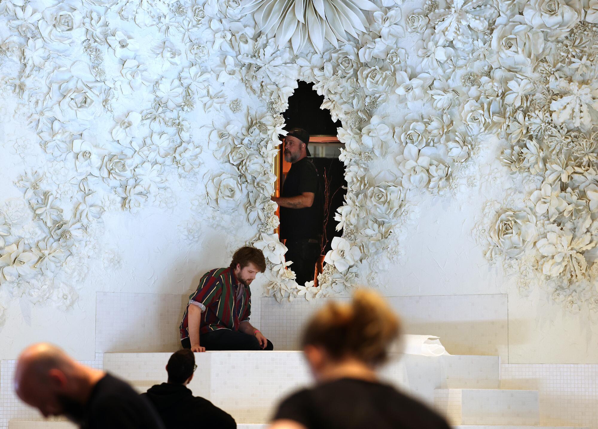 Stage walls covered in white floral plaster relief.