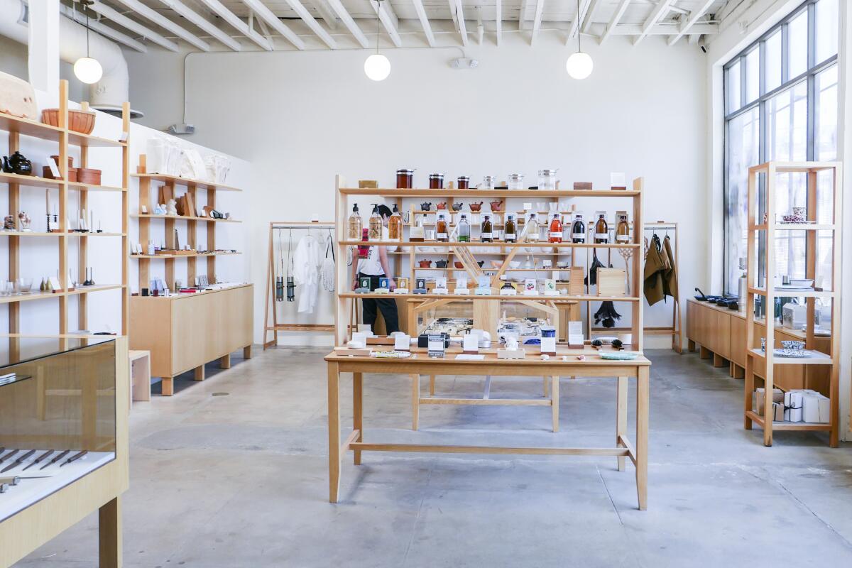 Minimalist store with white walls and light-wood display shelving