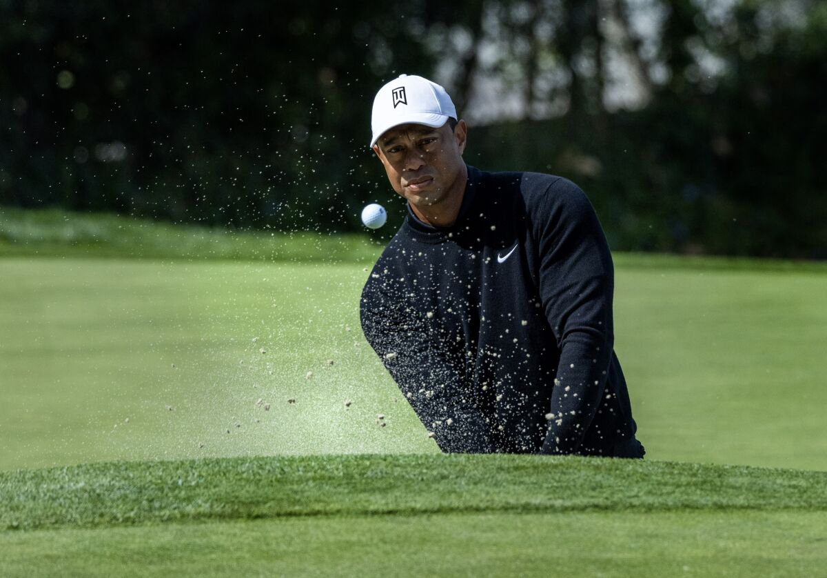 Tiger Woods hits out of sand trap on the sixth green during the second round at Riviera Country Club.