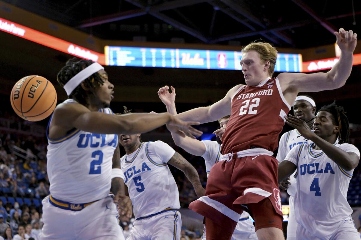 UCLA guard Dylan Andrews and Stanford Cardinal James Keefe go for a rebound Wednesday at Pauley Pavilion.