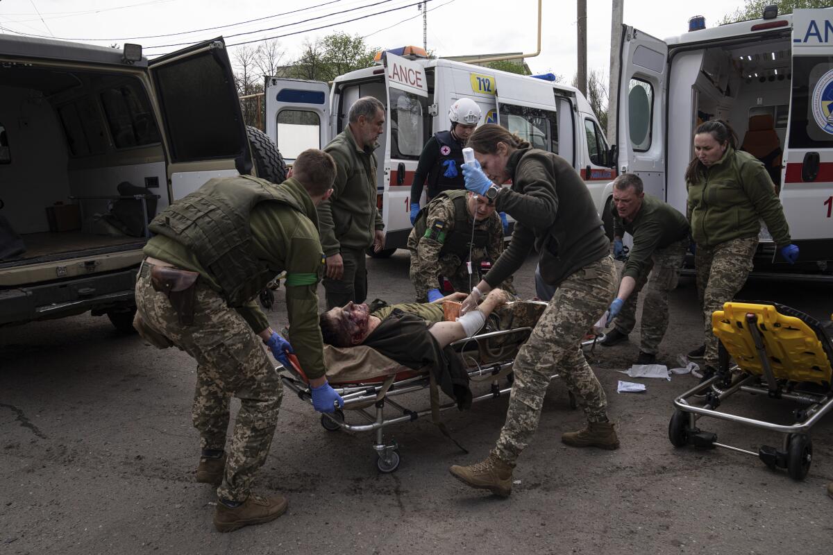 Medicsmove an injured Ukrainian serviceman to a hospital in Donetsk region.