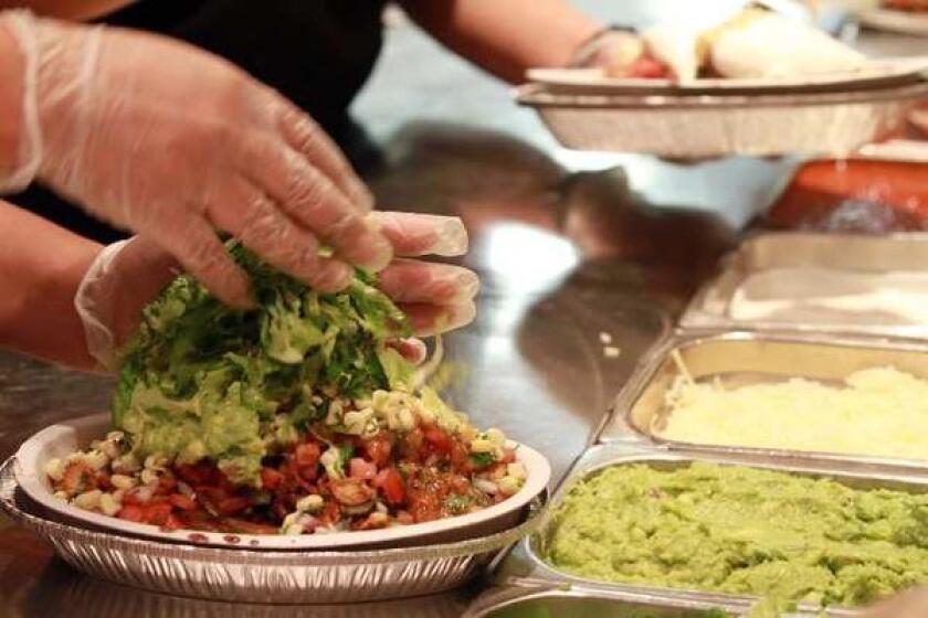The final touches are added to a Burrito Bowl at a Chipotle restaurant in Chicago.
