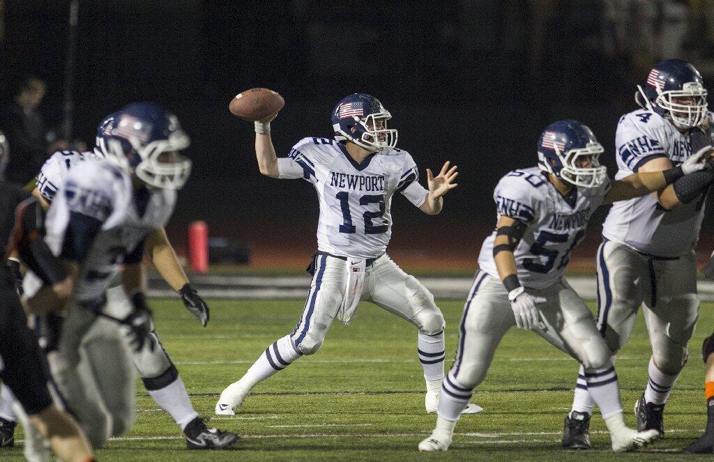 Newport Harbor's Cole Norris sets up to throw a pass during a game against Huntington Beach on Friday.