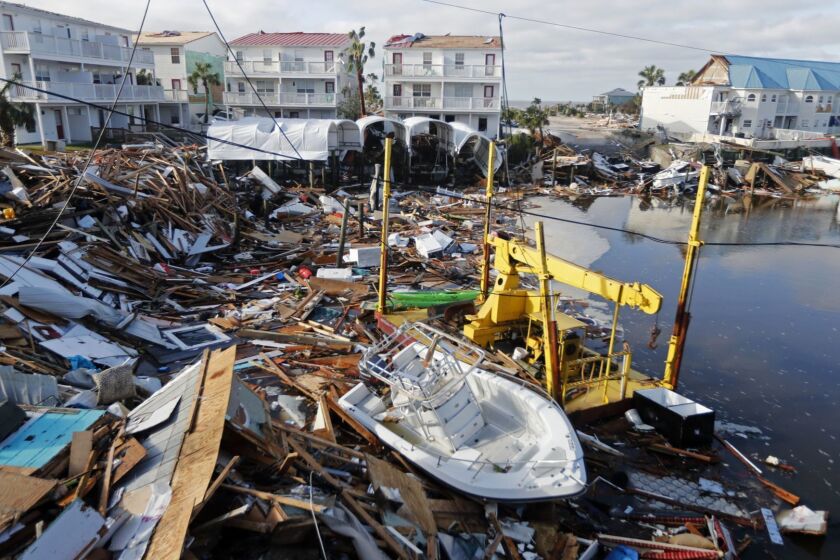 FILE - In this Oct. 11, 2018 file photo, a boat sits amidst debris in the aftermath of Hurricane Michael in Mexico Beach, Fla. Hurricane Michael has shown that President Donald Trump cant be counted on to give accurate information to the public when a natural disaster unfolds. (AP Photo/Gerald Herbert, File)