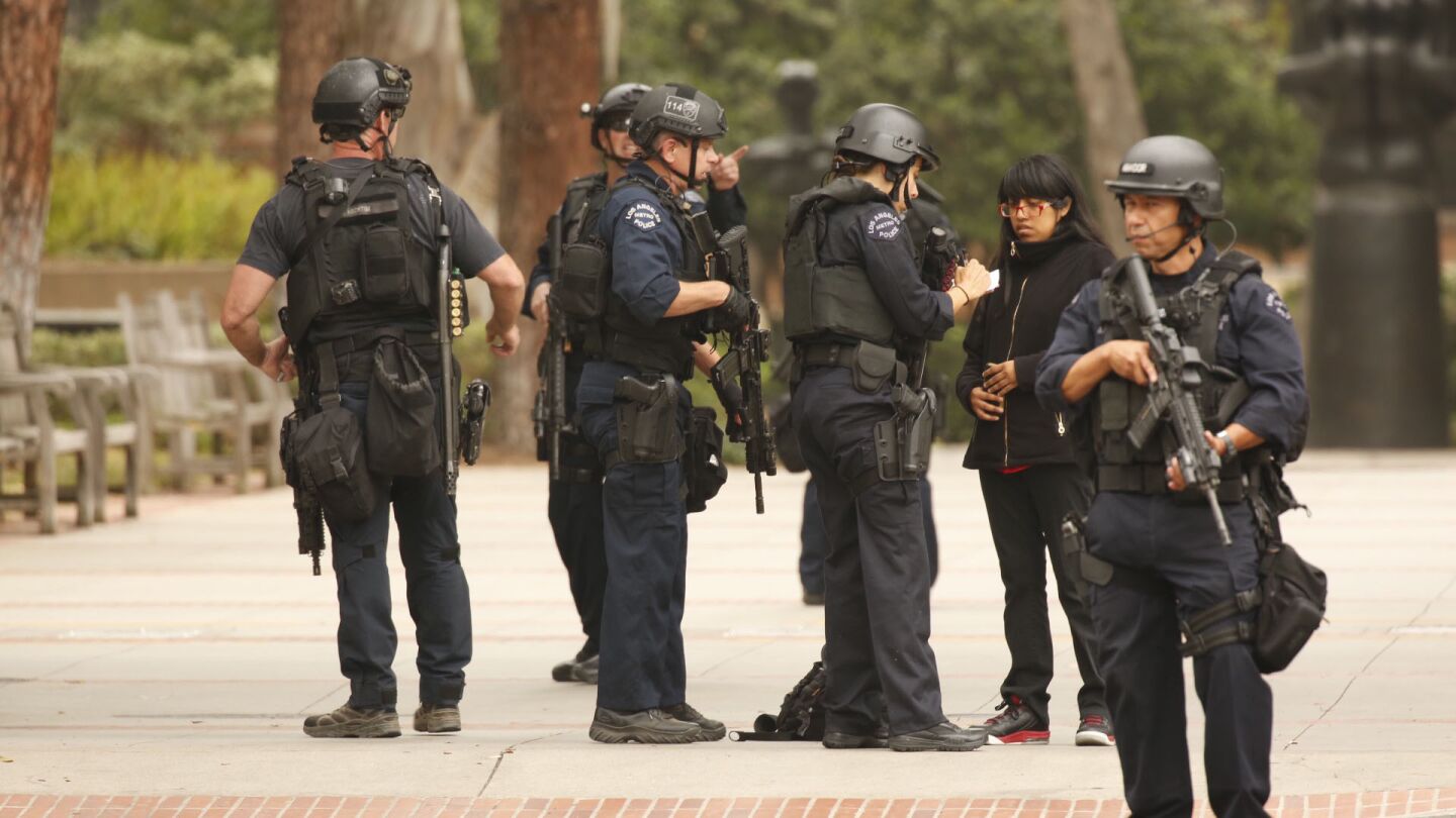 Police officers questions a students after a shooting at UCLA on Wednesday morning.