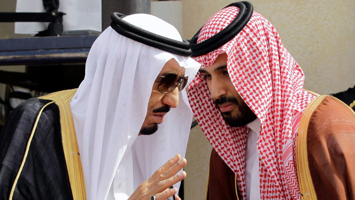 Saudi Arabia's King Salman, left, speaks with his son, now Crown Prince Mohammed bin Salman, in May 2012.