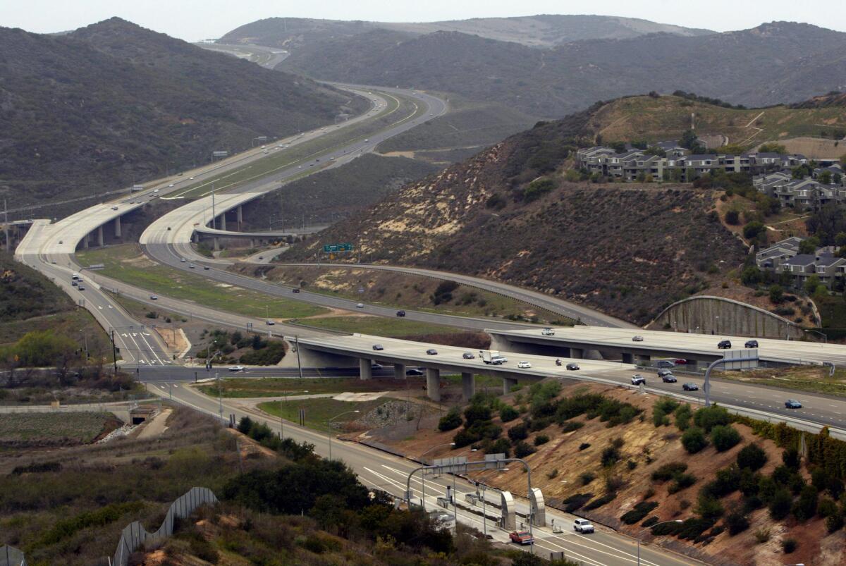 A view looking west from Aliso Viejo at the San Joaquin Hills Transportation corridor toll road where it crosses El Toro Road and snakes up the hill in Laguna Beach towards Newport Beach and Irvine. The photo was taken in 2004.