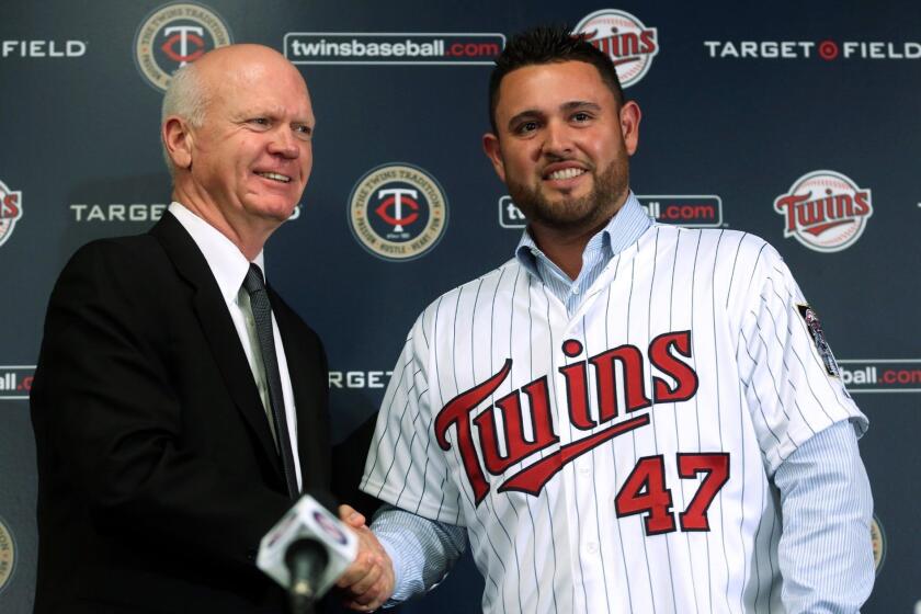 Former Dodgers pitcher Ricky Nolasco with Minnesota General Manager Terry Ryan after signing a four-year contract with the Twins on Wednesday.