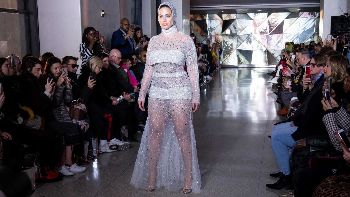 Ashley Graham closes the fall and winter 2019 Christian Siriano runway show in a crystal cascading-mesh gown.