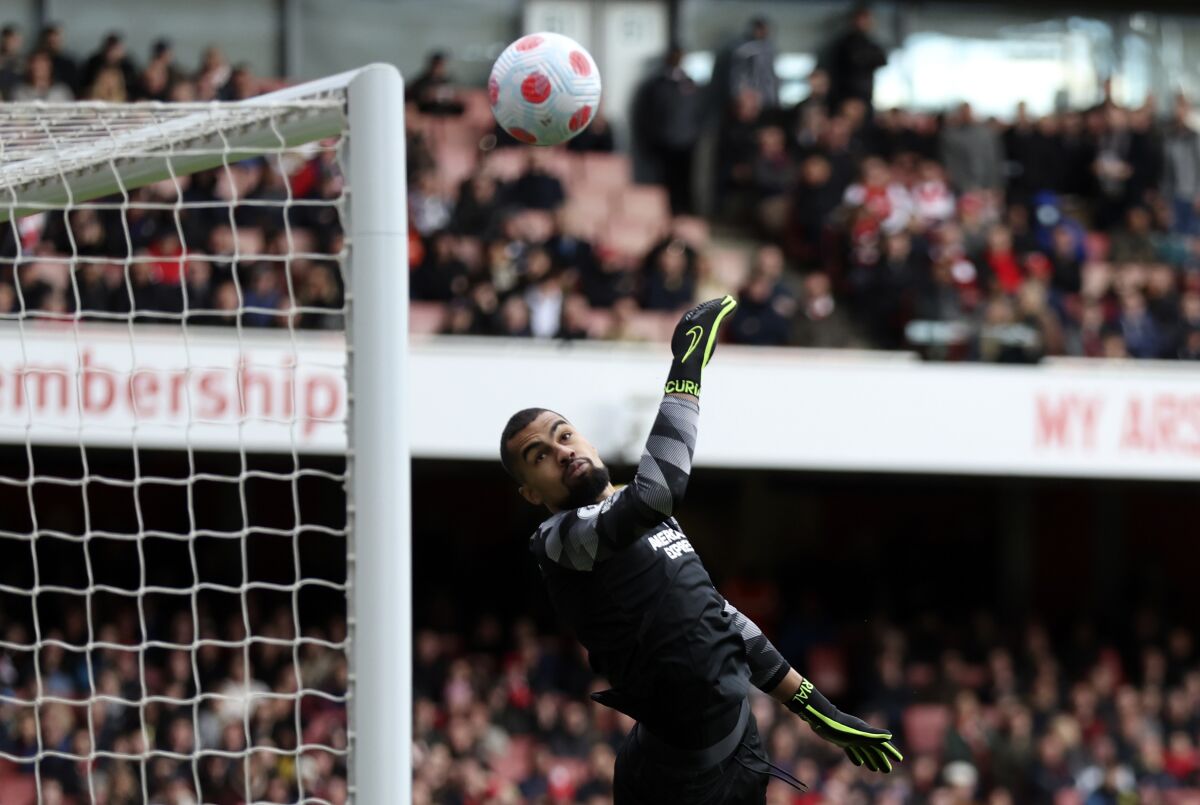 Brighton's goalkeeper Robert Sanchez receiving a goal from Arsenal's Martin Odegaard during the English Premier League soccer match between Arsenal and Brighton and Hove Albion at Emirates stadium in London, Saturday, April 9, 2022. (AP Photo/Ian Walton)