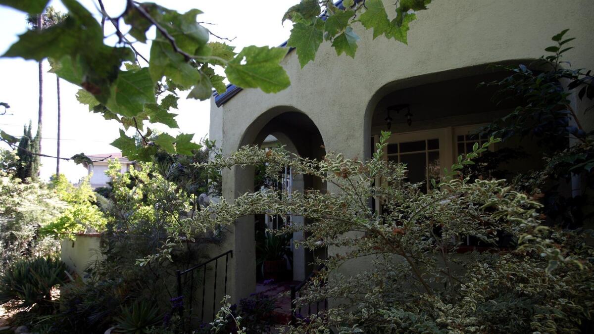 Judy Horton's garden surrounds a 1920s bungalow in Beachwood Canyon. Horton moved there in 2005 and is renting the home where she has planted a garden in every available space including her driveway which has become a nursery. A lofty Sycamore frames the front of the home.