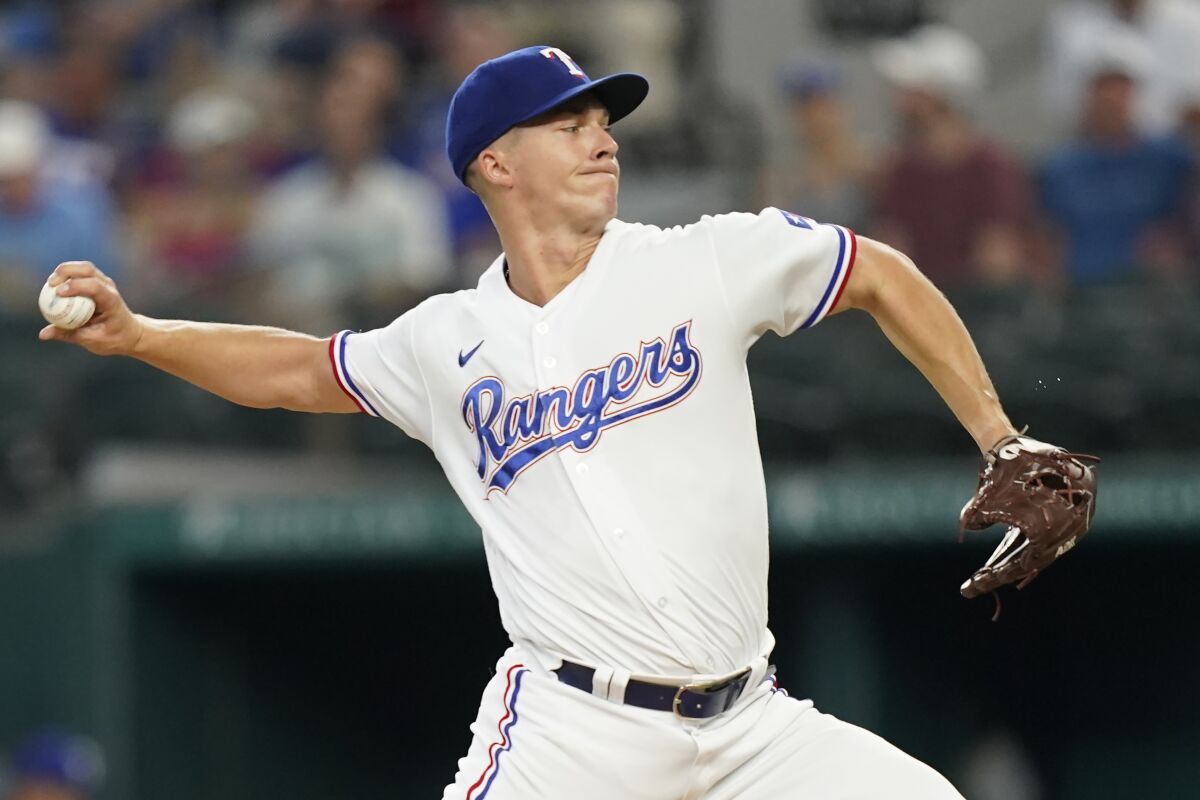 Texas Rangers starting pitcher Glenn Otto throws during the first inning of a baseball game against the Seattle Mariners in Arlington, Texas, Saturday, June 4, 2022. (AP Photo/LM Otero)