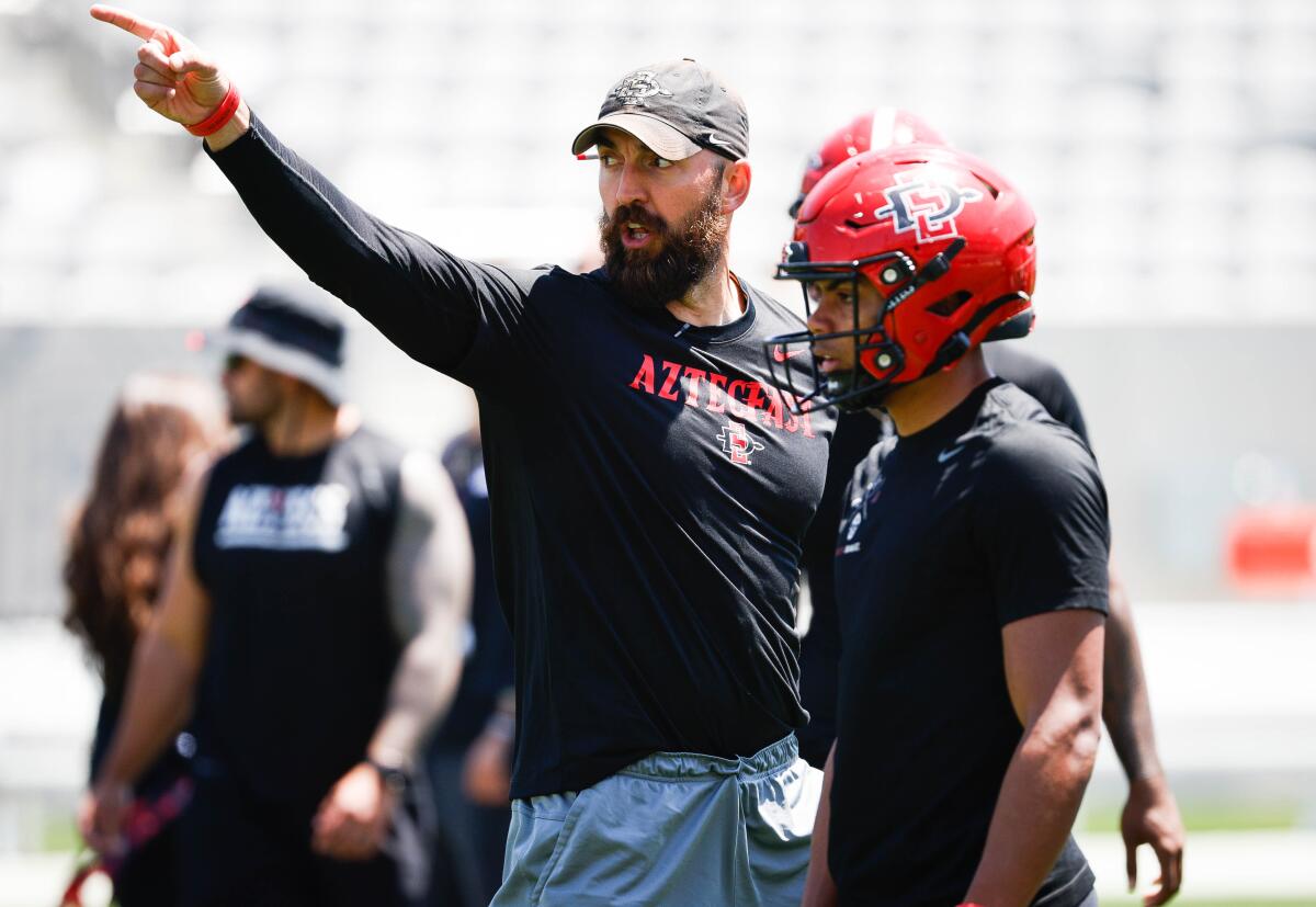 San Diego State head coach Sean Lewis points the way during the AztecFAST Showcase at Snapdragon Stadium.