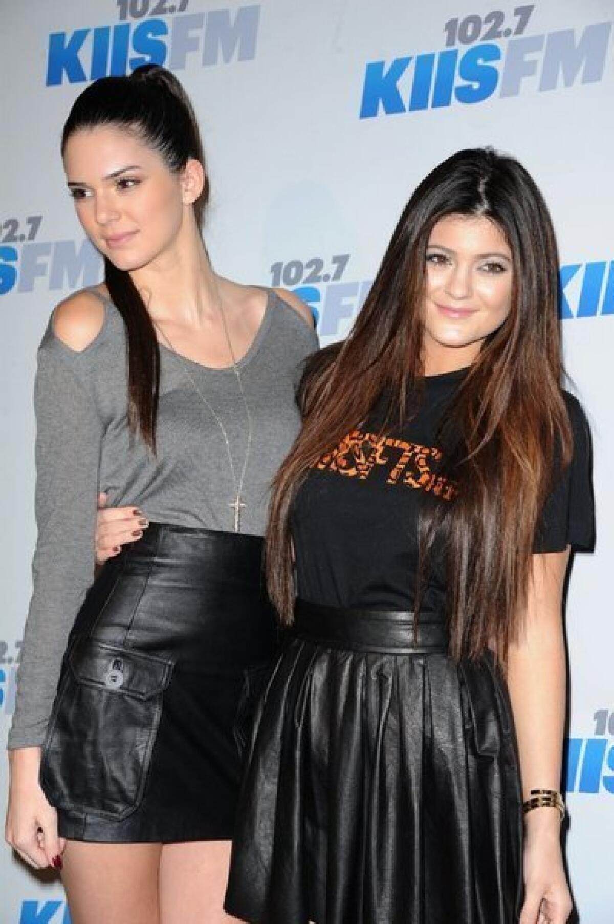 Kendall Jenner, left, and Kylie Jenner strike a pose at a holiday Jingle Ball at the Nokia Theatre this month.