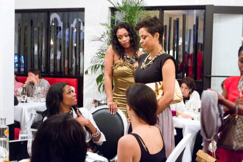 Shaunie O'Neal, center right, ex-wife of former basketball star Shaquille O'Neal, stars in and executive produces “Basketball Wives.” At center left is Tami Roman.