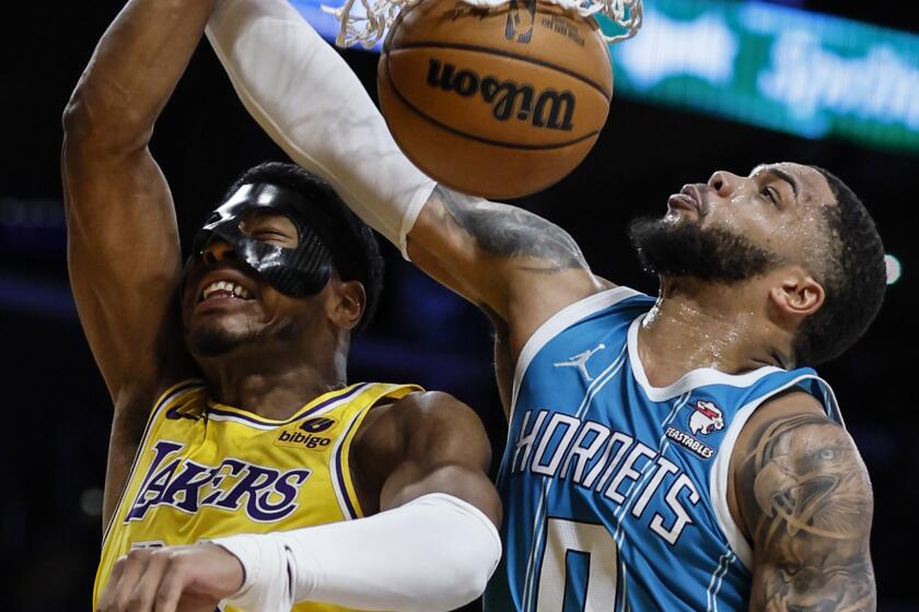  Lakers forward Rui Hachimura (28) slam dunks over Charlotte Hornets forward Miles Bridges (0) at Crypto.Com Arena. 