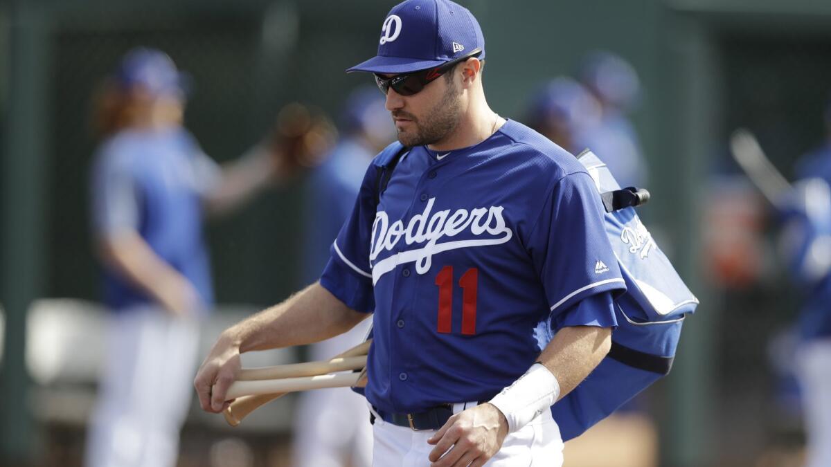 Dodgers' A.J. Pollock walks to the field for a spring training baseball game in Glendale, Ariz.