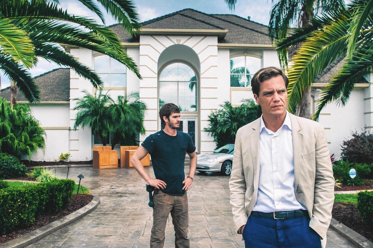Andrew Garfield stars as Dennis Nash and Michael Shannon as Rick Carver in the film "99 Homes."