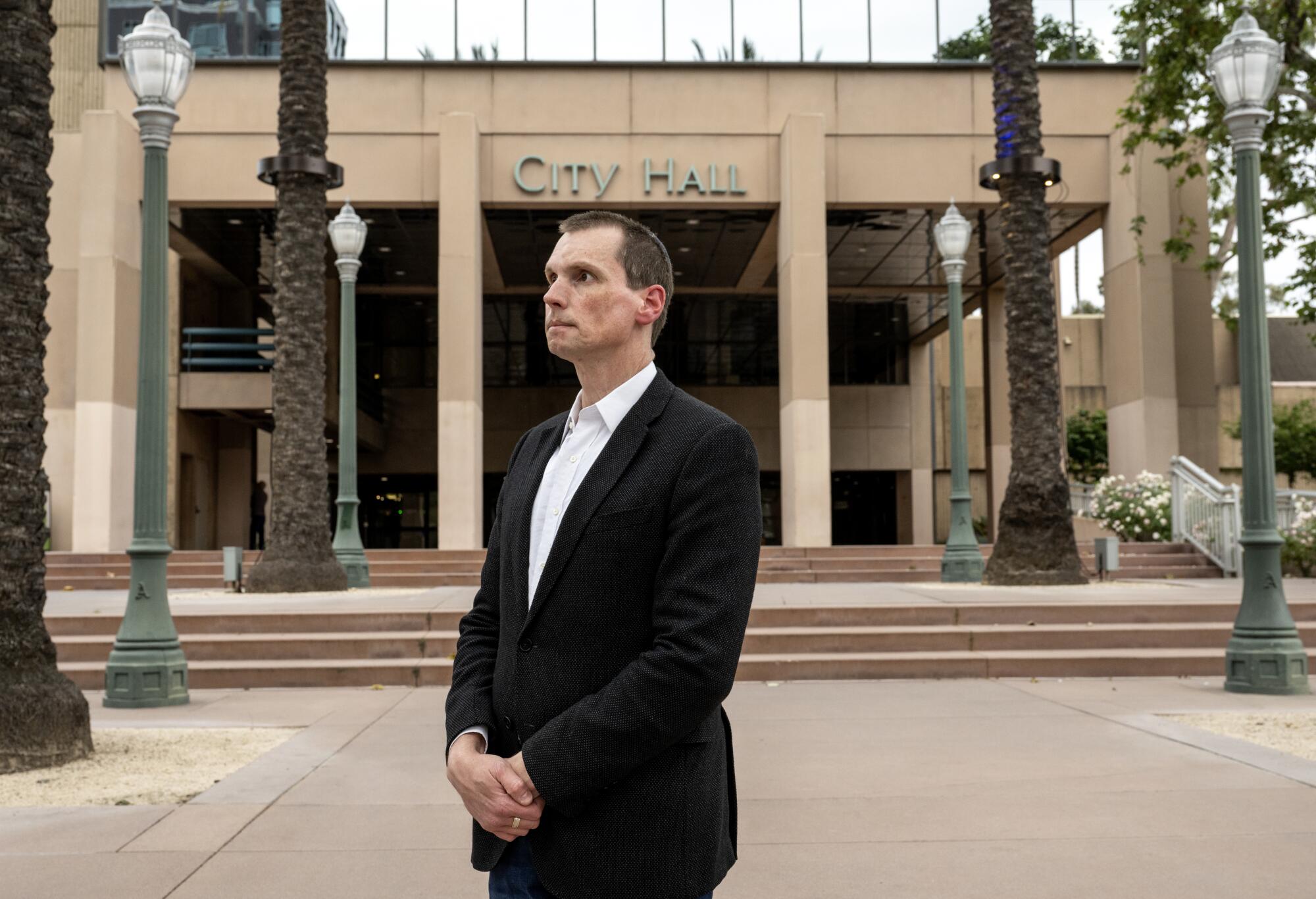 Former Anaheim Council Member Jordan Brandman stands in front of City Hall