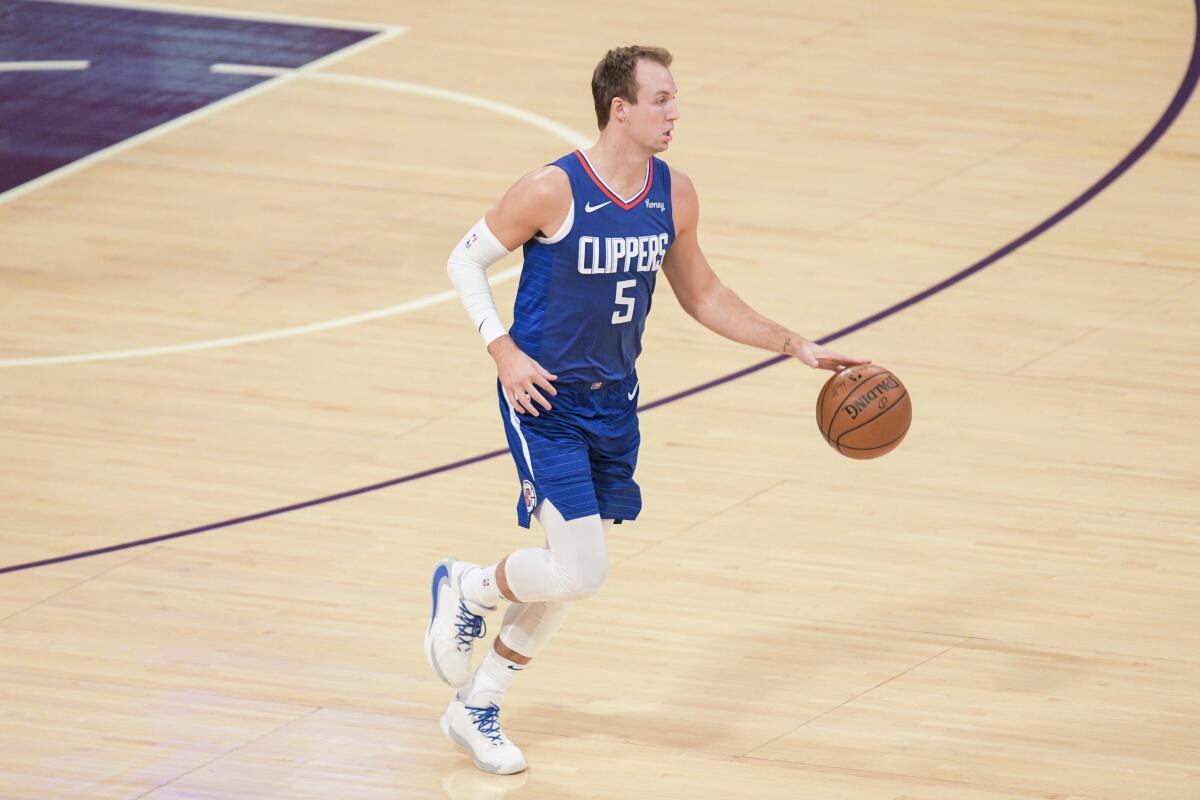 Clippers guard Luke Kennard brings the ball up court.