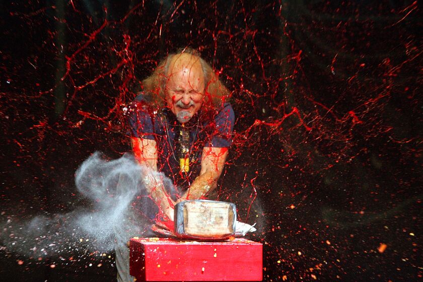 FILE - In this Nov. 18, 2006 file photo, comedian Gallagher smashes strawberry syrup and flour at the end of his performance at the Five Flags Theater in Dubuque, Iowa. The comedian known for smashing fruit and vegetables with giant wooden hammers says he was escorted out of Idaho's Statehouse in Boise by security when he entered the building carrying two of the hammers. Gallagher, whose full name is Leo Anthony Gallagher Jr., told the Idaho Statesman in a story on Wednesday, Aug. 28, 2019 that he was looking for the state's film office on Monday for a possible project. The state doesn't have a film office. (Jeremy Portje/Telegraph Herald via AP, File)