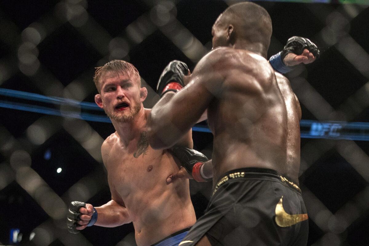 Alexander Gustafsson, left, throws a punch at Jon Jones during their light-heavyweight fight at UFC 165 on Saturday.