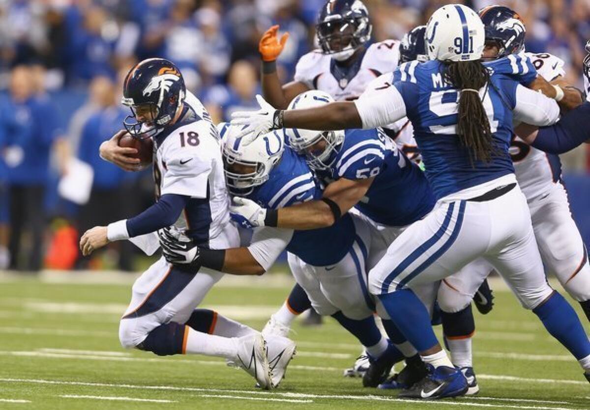 Peyton Manning of the Denver Broncos is sacked during Sunday's game against the Indianapolis Colts.