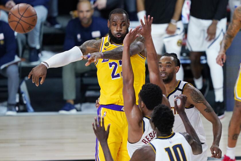 Los Angeles Lakers' LeBron James (23) passes the ball during the second half of an NBA basketball game.